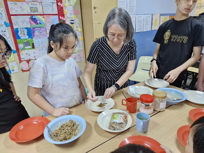 A group of people at a table with plates and food

Description automatically generated